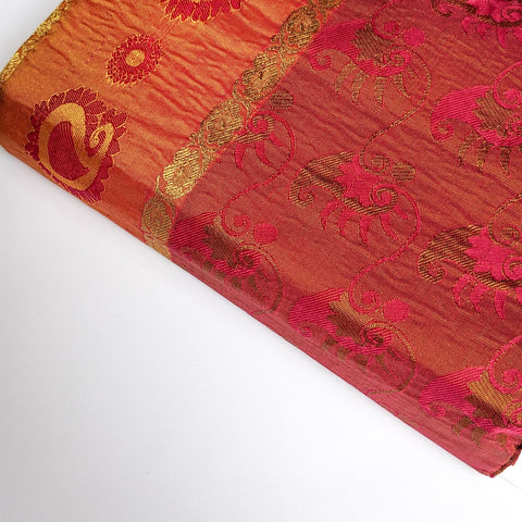 Decorative fabric with intricate patterns on a white background