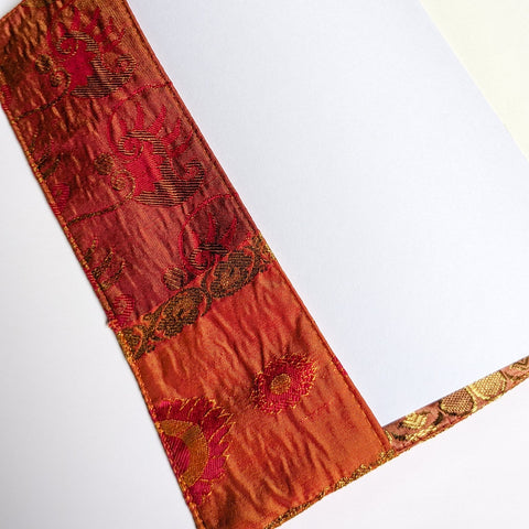 Decorative book with a red floral pattern on a white background