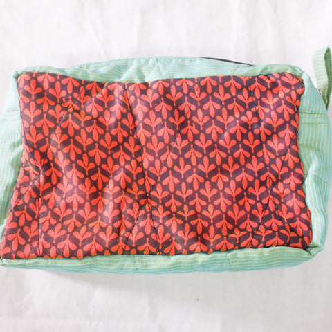 Rectangular pouch with red and black pattern on a white background