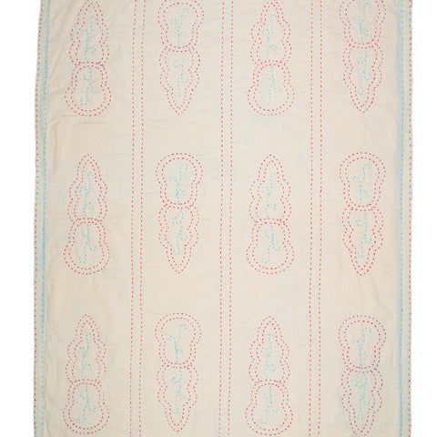 Quilt with embroidered pattern on a white background