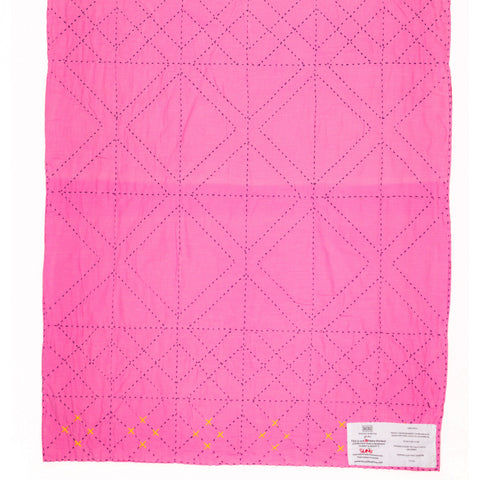 Pink quilt with diamond pattern on a white background