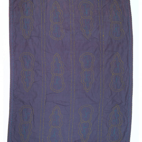 Purple quilt with geometric pattern on a white background