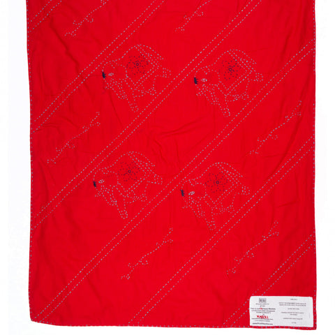 Red blanket with black patterns on a white background