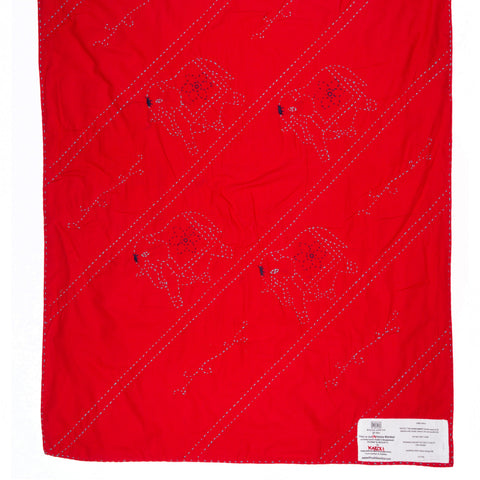 Red blanket with black patterns on a white background