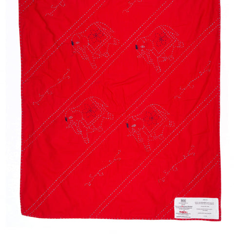 Red blanket with black patterns on a white background