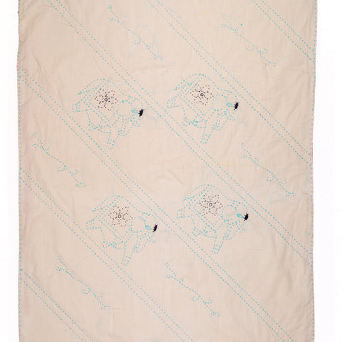 Beige quilt with embroidered patterns on a white background