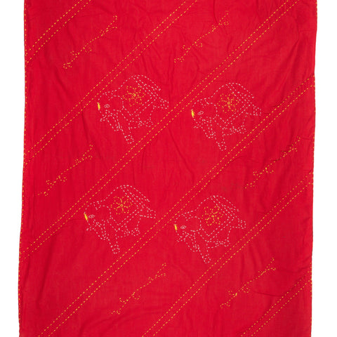 Red quilt with white animal patterns and diagonal stitching on a white background
