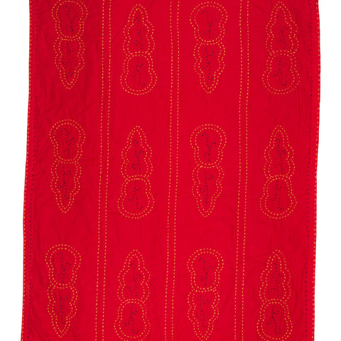 Red fabric with embroidered patterns on a white background