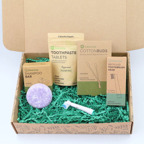 A sustainable eco gift box with shampoo bar, electric toothbrush, toothpaste tablets and bamboo cotton buds for a plastic-free bathroom routine