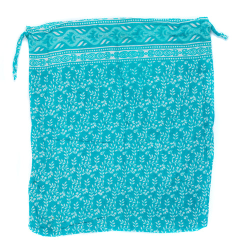 Turquoise drawstring bag with white floral pattern on a white background
