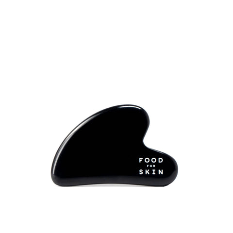 Packshot van Gua Sha massagesteen van lavaglas