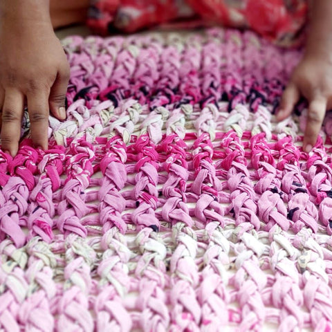 artisan working on pink chunky knit cushion cover