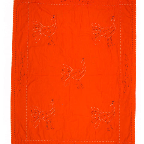 Orange fabric with embroidered chicken patterns on a white background