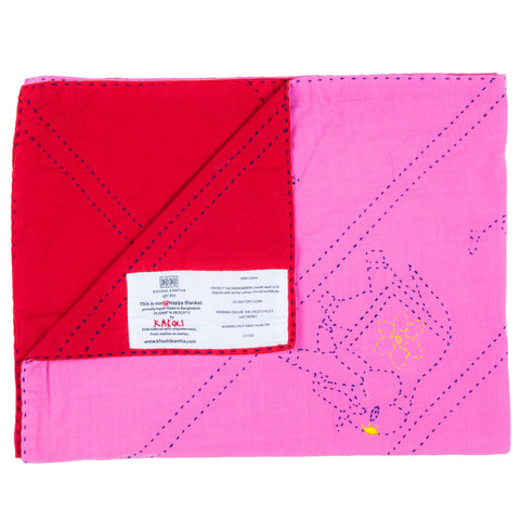 Pink and red quilt with a label on a white background