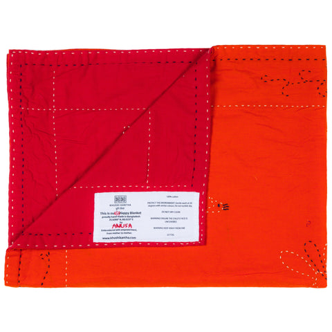 Red and orange fabric with a visible brand label on a white background