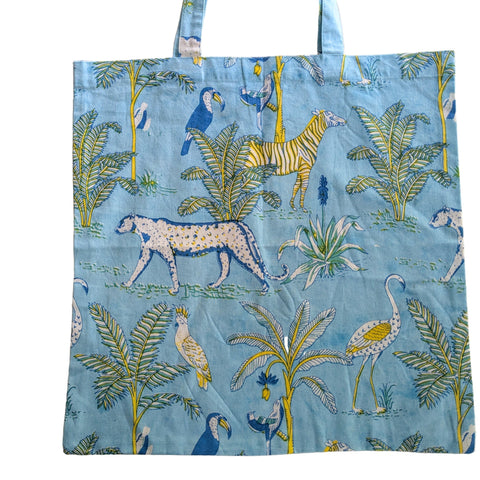 Tote bag with animal and plant pattern on a blue background