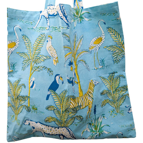 Tote bag with tropical animal and plant pattern on a blue background
