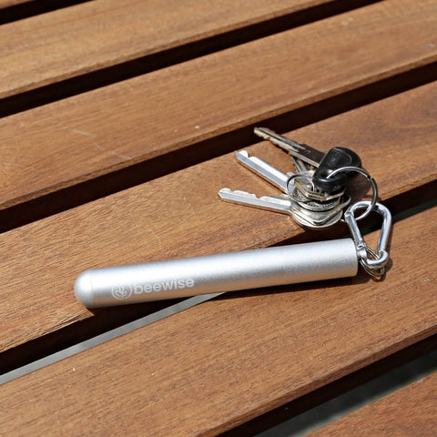 eco-friendly reusable straw collapsible silver case and silver colour being used attached to a keychain