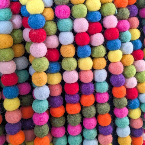 Multicoloured felt ball garlands with a close-up view