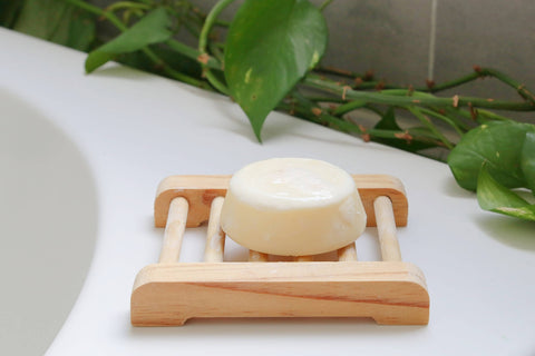 conditioner bar lavender solid bar lavender handmade in the netherlands on top of the bath inside a bathroom