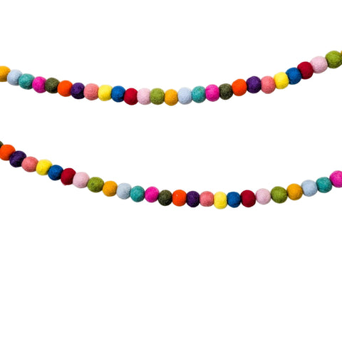 Colorful felt ball garland on a plain background