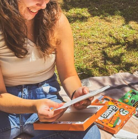Girl holding erasable pen-on-paper games