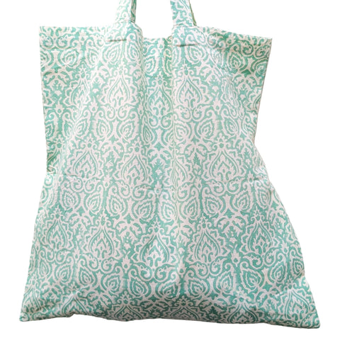 Patterned green and white tote bag on a light gray background