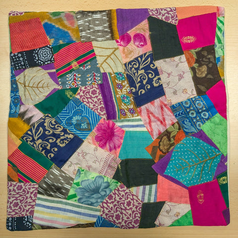 Handmade Patchwork Sari Cushion Cover placed on a wooden surface