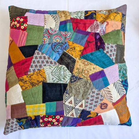 Sari patchwork cushion with cover on lying on a white surface