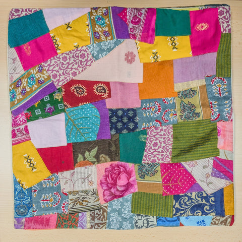 Handmade Patchwork Sari Cushion Cover placed on a wooden surface