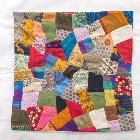 Sari patchwork cushion cover lying on a white surface