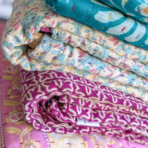 stack of kantha blankets