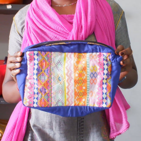 blue fabric sari box pouch held by artisan model