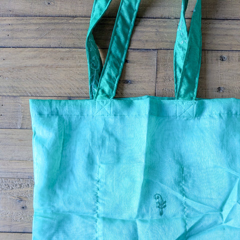 green sari tote bag on wooden background