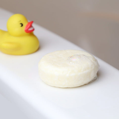 sustainable and eco-friendly natural shampoo bar for baby and kids together with a play plastic duck