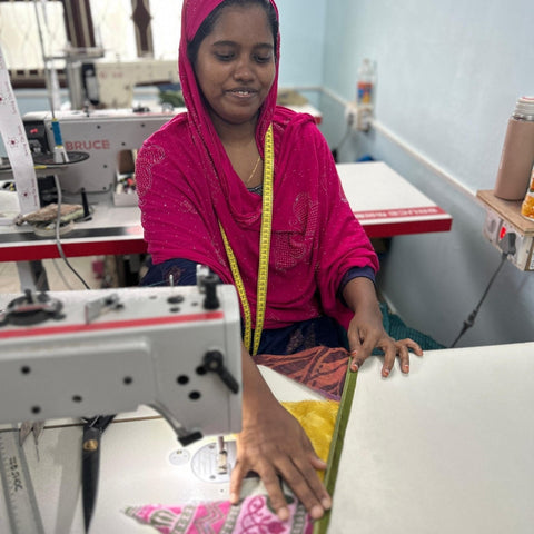 artisan sewing sari flags