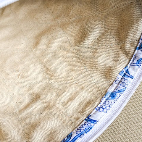 interior view of white blue block printed quilted pouch