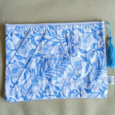 white blue block printed quilted pouch on beige surface